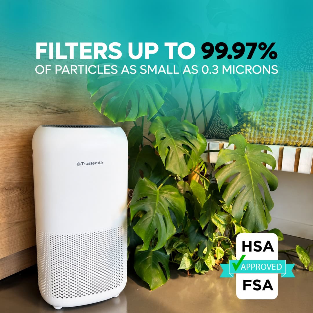 TrustedAir TruFlow Smart HEPA Air Purifier filters up to 99.97% of particles as small as 0.3 microns, ideal for large rooms, with a sleek white design and green indoor plants.
