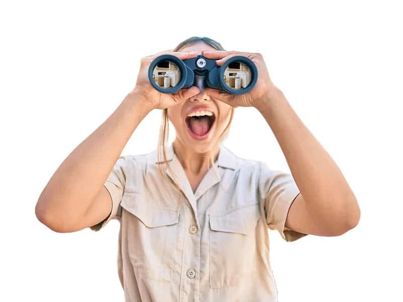 Close-up of a woman looking through binoculars, excited about air quality or air conditioning services.