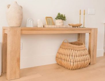 Clean air purifier next to a wooden console table in a modern, minimalistic home interior.