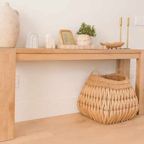 Clean air purifier next to a wooden console table in a modern, minimalistic home interior.