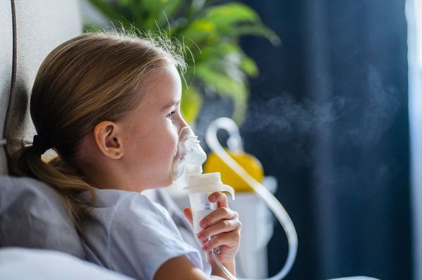 girl with asthma breathing with nebulizer