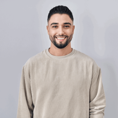 Fresh-faced man smiling in a casual beige sweater for a trusted air service image.