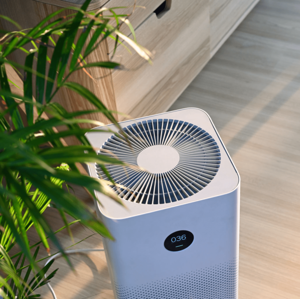 Portable air purifier with digital display in modern home, improving indoor air quality.