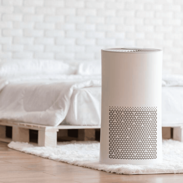 Air purifier in a bedroom for clean air and improved indoor air quality for healthier living.