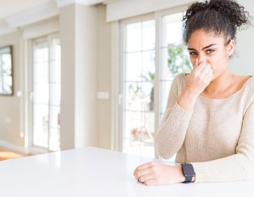 Nasal congestion and allergic symptoms in a young woman indoors, Poor indoor air quality concept.