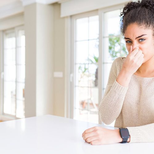 Nasal congestion and allergic symptoms in a young woman indoors, Poor indoor air quality concept.