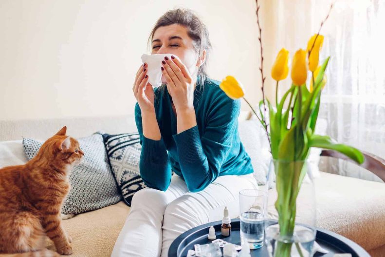 woman sneezing with allergies
